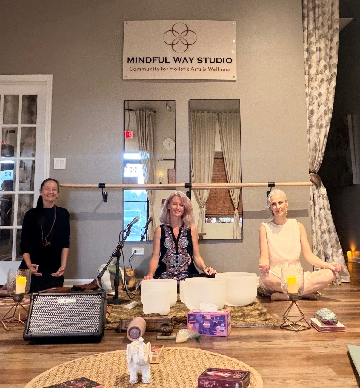 Treya, Desirea, and Ania Haas — three wellness facilitators at Mindful Way Studio in Mokena Illinois — seated together with crystal singing bowls and candles for the Beyond Polarity Full Moon Ceremony September 26 2026, sound bath energy healing and guided meditation event in the south suburbs of Chicago IL