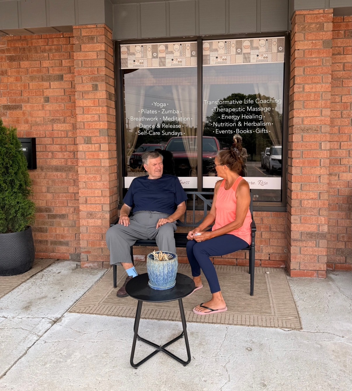 Two people in conversation outside Mindful Way Studio storefront in Mokena IL — yoga, massage, breathwork and energy healing