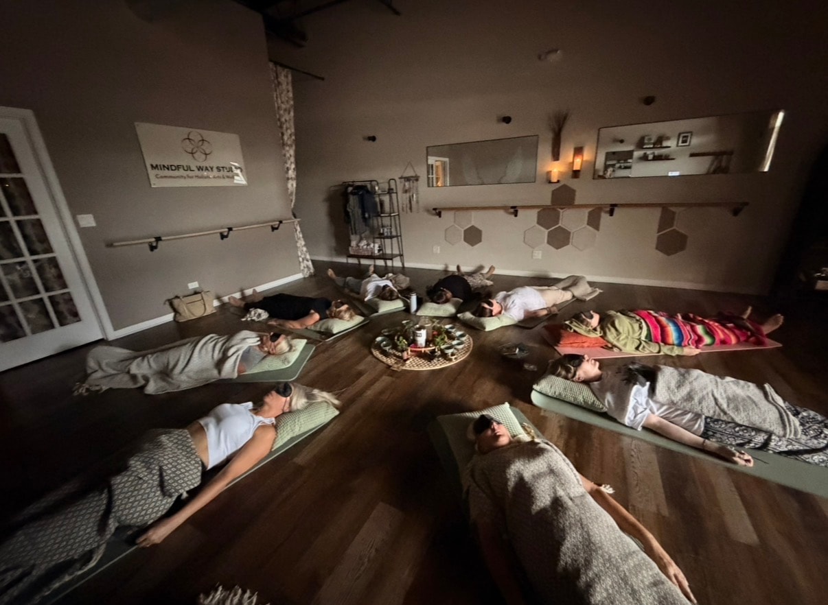 Participants lying in savasana during Cacao Ceremony breathwork session at Mindful Way Studio, Mokena IL