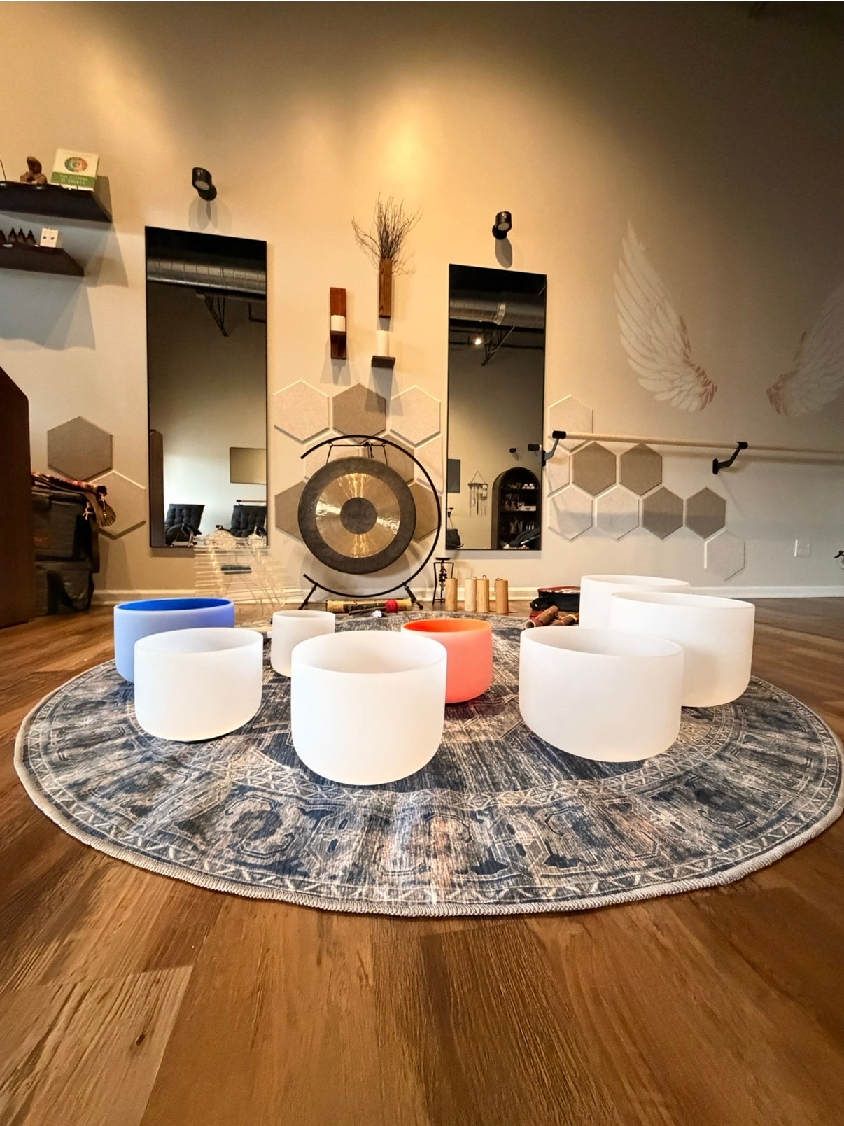 Crystal singing bowls arranged in a circle on a mandala rug