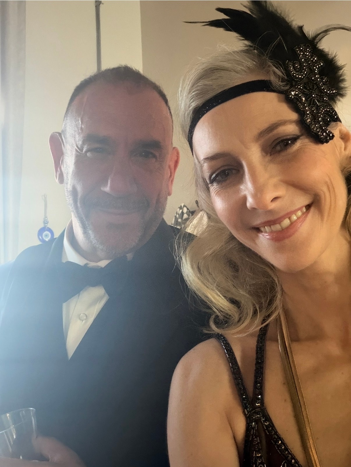 Two people in Gatsby attire taking a selfie at the themed event