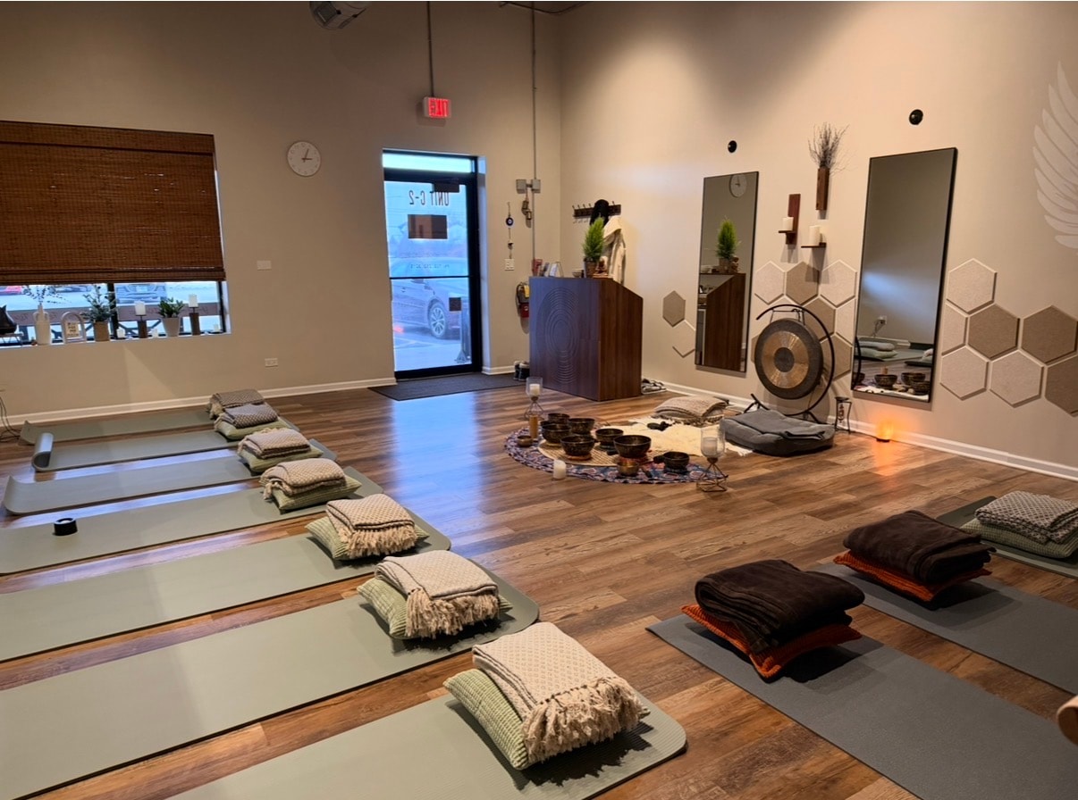Studio set up for a sound bath with mats, blankets and singing bowls